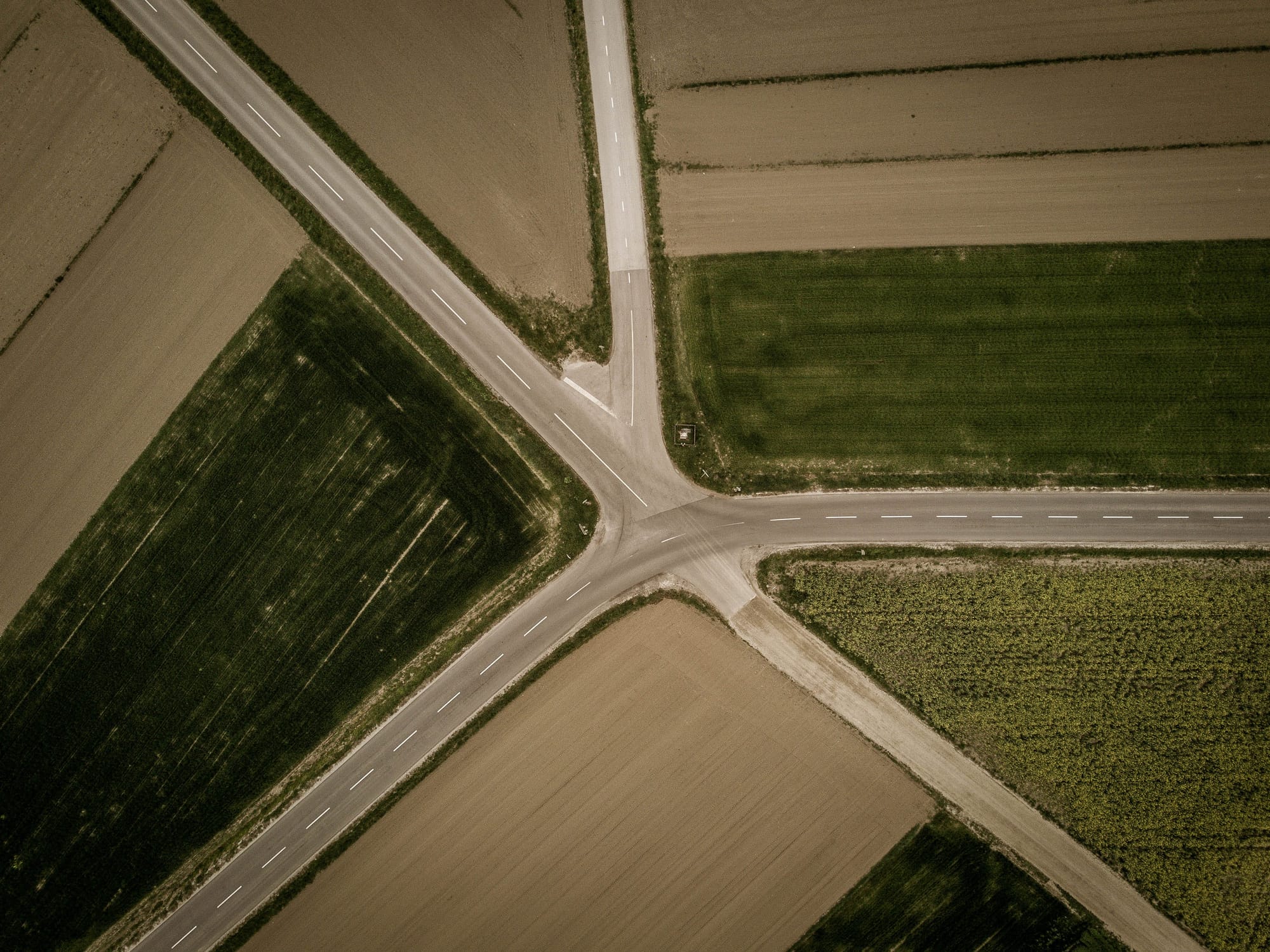 Aerial image of fields and five converging roads.