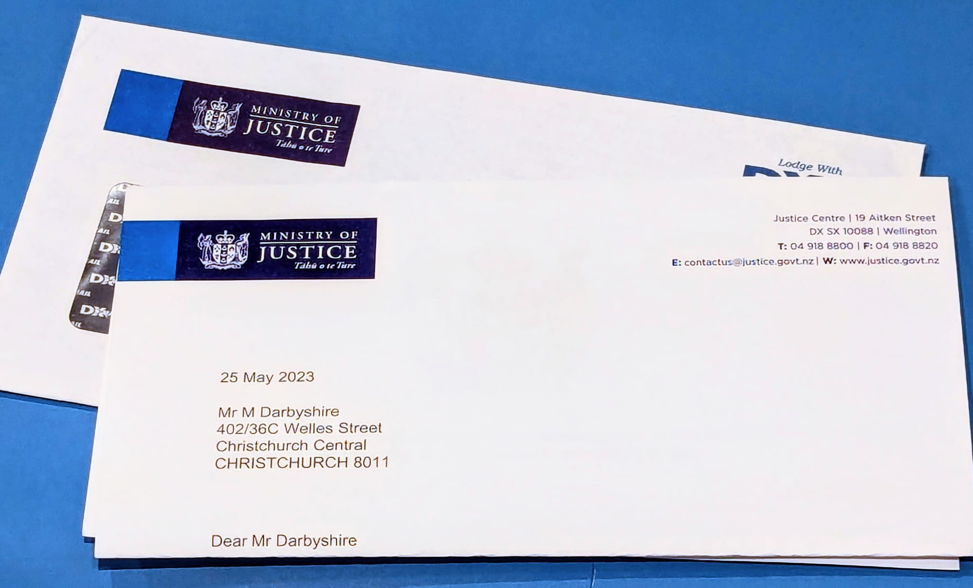 A folded letter and envelope from the Ministry of Justice on 25 May 2023 addressed to Mr M Darbyshire.